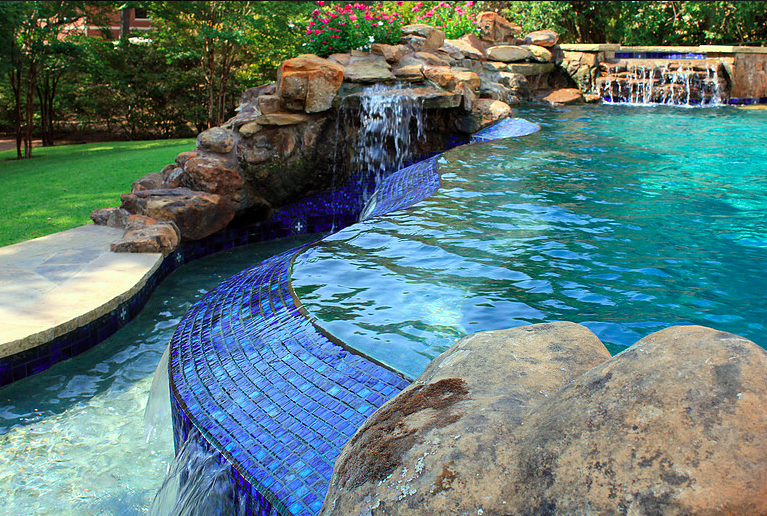 Swimming pool with rocks and waterfall