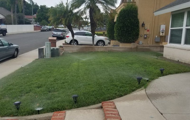 inground sprinklers on residential front lawn